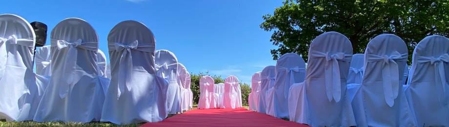 Roter Teppich und Stühle mit Hussen für Hochzeit